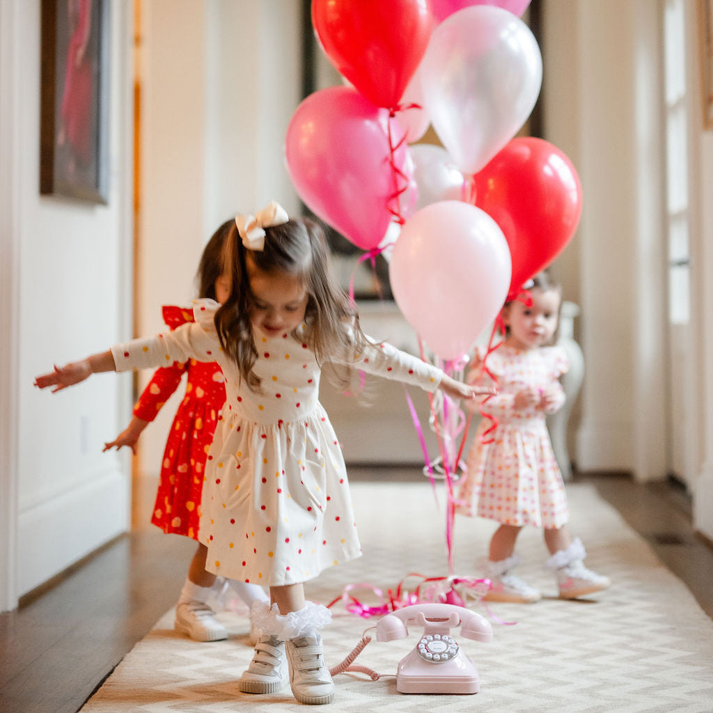 little girls play dress with polka dots
