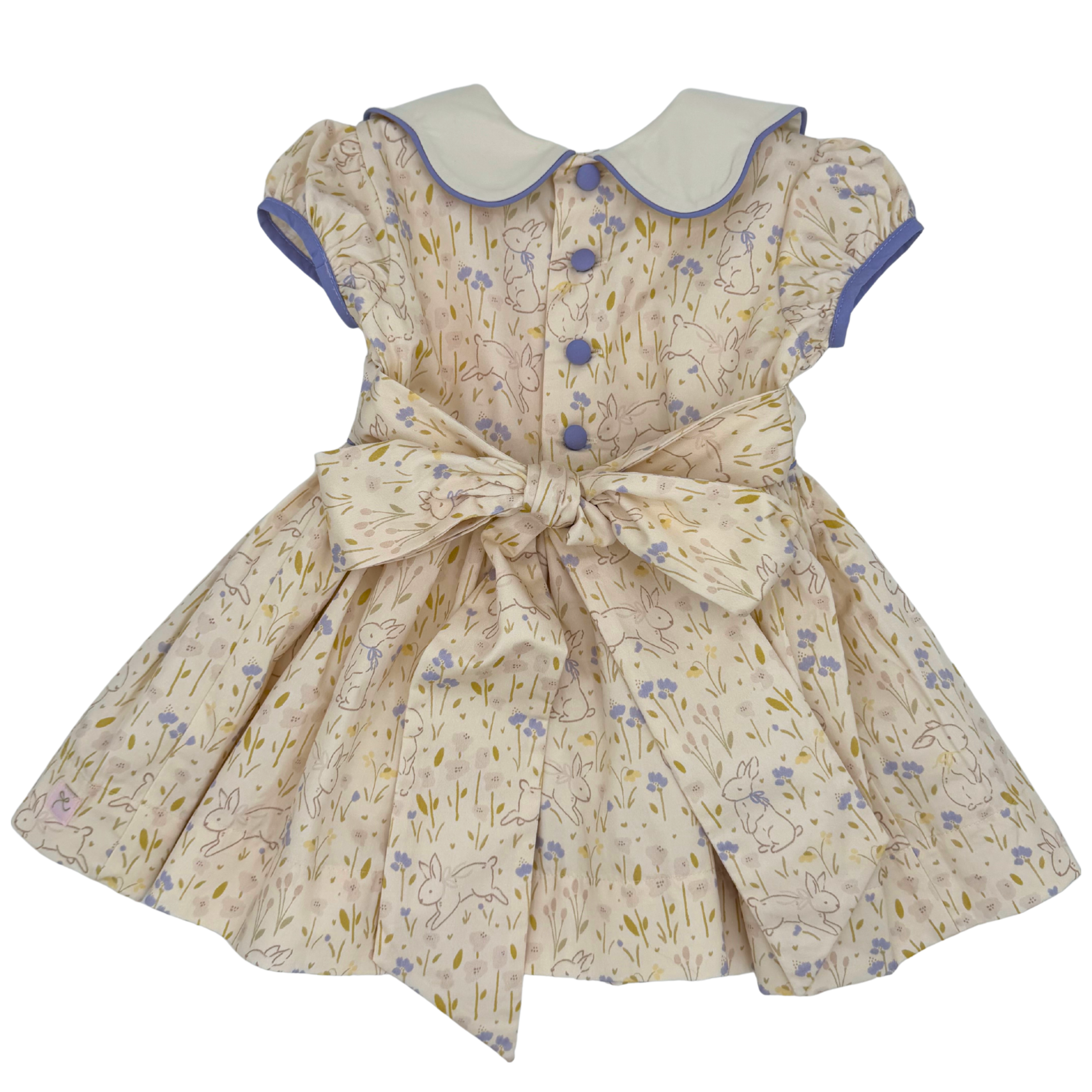 Children's dress with floral pattern and bow on a white background
